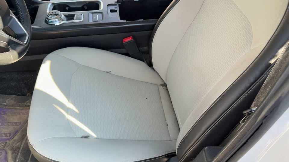 Car seat with visible dirt and staining before detailing