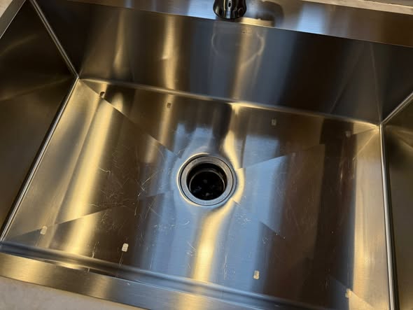 Stainless kitchen sink polished to a shine